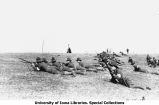 Cadets lying on field with rifles at Camp Macbride, The University of Iowa, April 14, 1917