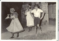 Carmen in uniform center dancing with two other women in Tobago