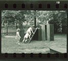 Children climbing on wood platforms and slides, The University of Iowa, May 10, 1941