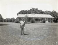 Man stands in front of ranch style house