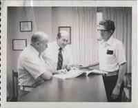 State Conservationist, Bill Brune, center, looks at a watershed plan with Wayne Ducommun, SCS Engineer, on the right, and Henry D. Tordoff, District Conservationist.<br />
