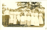 Group of men and women posing outside, Iowa, 1910s