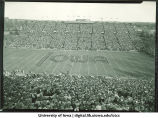 Marching band performing at football game, The University of Iowa, November 1955