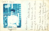 Frowning woman in front of house, Coralville, Iowa, October 2, 1906