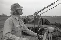 1979  Three views of man driving Caterpillar 613 earthmoving machine