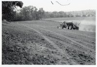 1978 Man on tractor with wagon plants seed
