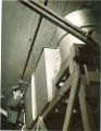 Engineering student standing near large metal containers in Engineering laboratory, The University of Iowa, 1939