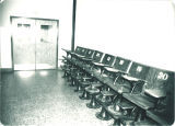 Seats from Zoology Building room 201 displaced for renovations and stacked in 2nd floor hallway, The University of Iowa, 1982