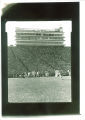 Sideline shot of football game and west side stands in Kinnick Stadium, the University of Iowa, 1961