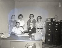 One Man and Five Women at Desk