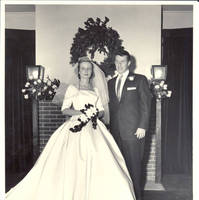 Frindy and John, Sr. in front of fireplace in living room