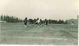 Scottish Highlanders marching on athletic fields near University Hospitals, The University of Iowa, 1930s
