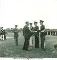 Man presents soldiers with awards, The University of Iowa, 1950s