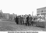 Governor's Day ceremony, VIPs standing next to awards table, The University of Iowa, 1930