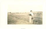 Woman posing with flowering plants, Iowa?, 1910s