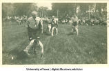 Human wheelbarrow race at City Park for Senior Frolic, The University of Iowa, 1910s