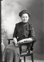 Woman with glasses, seated