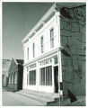 Man in doorway of the Campus Stores on North Clinton Street, The University of Iowa, 1950s