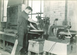 Drama student drilling a block of wood for set building, The University of Iowa, April 4, 1941