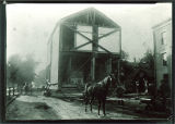 Horse and workmen moving a building on campus, The University of Iowa, 1890s