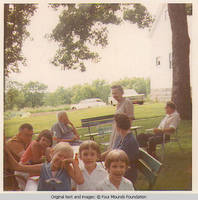Heitzmans seated at bench