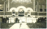 Crowd of men and women posed outside banquet hall, Reinbeck, Iowa, August 28, 1914