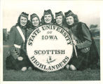 Members of Scottish Highlanders grouped around bass drum, The University of Iowa, 1948