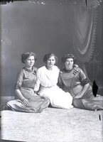 Three women seated on floor