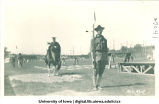 Cadets and student in cap and gown on horseback for Senior Frolic, The University of Iowa, 1910s