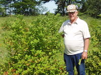 Unidentified farmer on his farmland with family