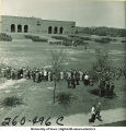 Crowds watch soldiers marching formations next to Kinnick Stadium, The University of Iowa, 1950s