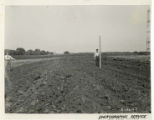 Two men measuring a plowed furrow, 1942