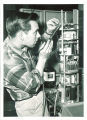 Electrical engineering student Donald Enemark using soldering iron, The University of Iowa, 1958