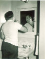 Man shaving in South Quadrangle, The University of Iowa, January 1948