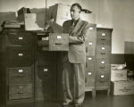Robert W. Orr examining files, 1953