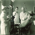Dental instructor and dental student examining patient, The University of Iowa, 1940s