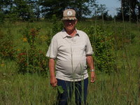 Unidentified farmer on his farmland with family