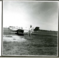 Man Poses in Front of an Airplane