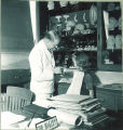 Dentist showing plaster cast of teeth to young girl, The University of Iowa, 1940s