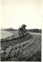 Men in field on farm machinery 