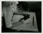 Student performing plane table surveying using an alidade, 1957