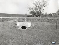 Water culvert with fence by road