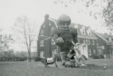 Delta Sigma Phi Homecoming lawn display with large football player and three smaller figures, 1962