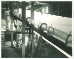 Engineering student with long cylinder in engineering laboratory, The University of Iowa, 1939