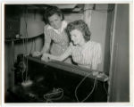 Two cadettes are working with a control system for a wind tunnel test, 1943