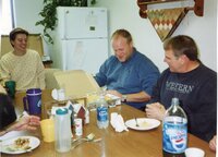 2005  NRCS Soil Conservationist TJ Mathis and District Employee Dale Schmeiser sit at a table