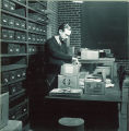 Man opening a box of plant specimens, The University of Iowa, 1950s