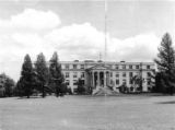 Curtiss Hall, front (west) façade framed by pine trees