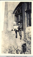 Vidie and Frindy Burden sitting on ledge with Rosie, the doll playing "horsie"