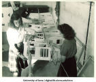 Elinor Kohrs, Harriet Brown, and Idella Benton with pre-flight signal code flags, The University of Iowa, 1942-43